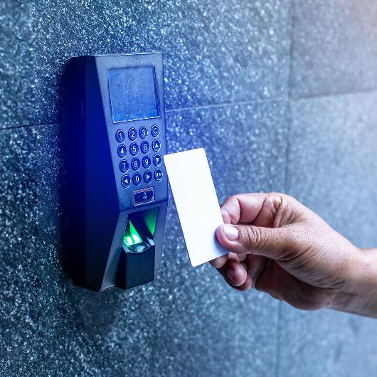 Hand tapping security card on access control system